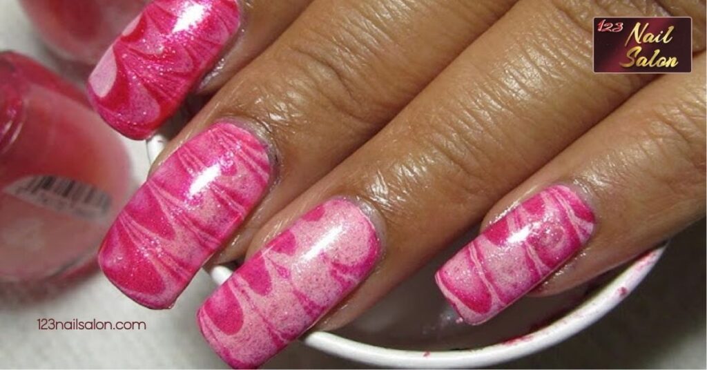 10 Creative Breast Cancer Awareness Nail Ideas to Show Your Support This October 7 Water Marble Breast Cancer Nail Art